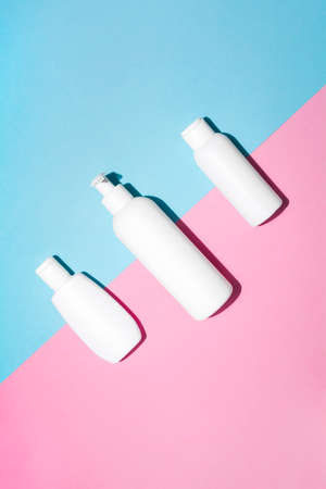 Mock up pattern for branding on pastel pink and blue background. Tubes, dispensers and jars....