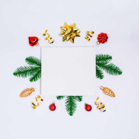 Christmas postcard with paper blank, golden decorations, fir tree branches, confetti and sparkles on...