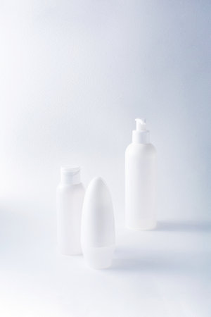 White bottles mockup for branding. Set of cosmetic products for cream, soup, deodorant, shampoo on light background. Tubes, dispensers and jarsの写真素材