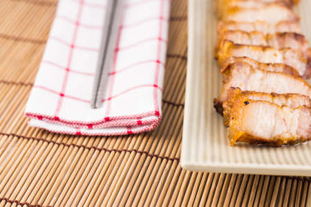 Picture of roasted pork and chopsticks on wooden backgroundの写真素材