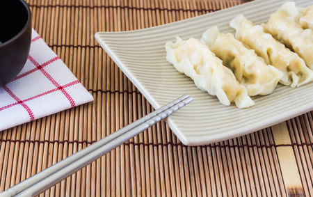 Picture of wonton and chopsticks on wooden backgroundの写真素材