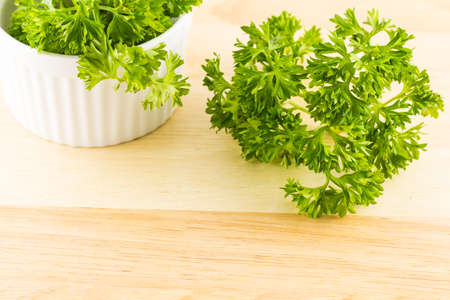 Fresh green parsley on wooden background