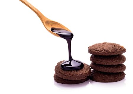 Chocolate cookies and chocolate topping on white backgroundの写真素材