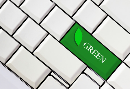 Green key on white keyboard, green conceptの写真素材