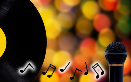 Music concept, record and microphone on blur bokeh background with copy spaceの写真素材