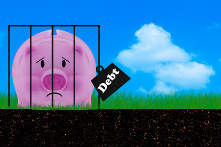 Debt concept, financial crisis, piggy bank on blue sky backgroundの写真素材