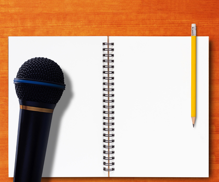 Journalist interview concept, open notebook and yellow pencil on wood backgroundの写真素材