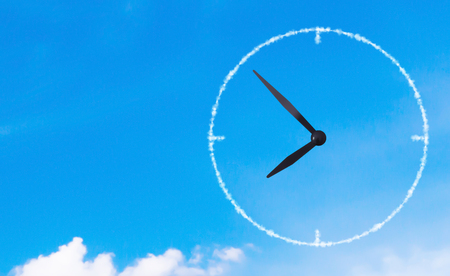 Time management concept, business planning, cloud clock on blue skyの写真素材