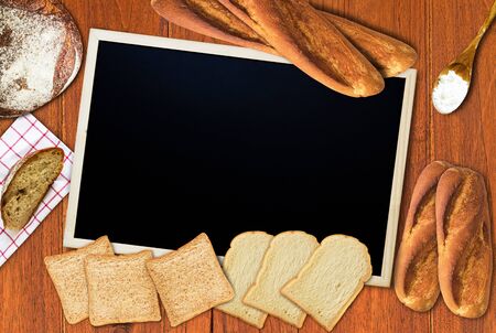 Homemade bakery, bread on wood table background, blackboard, chalkboard menuの写真素材