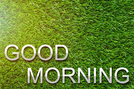 Good morning and wake up concept, greeting paper cut text on green grass backgroundの写真素材