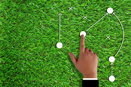 Business strategy and planning concept, hand and direction icon on green grass backgroundの写真素材