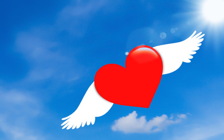 Red paper heart flying on blue sky background, valentine day, romantic and falling in love conceptの写真素材