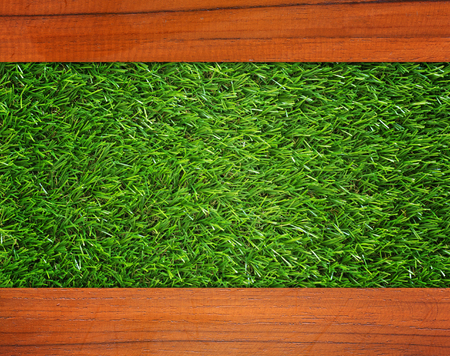 Wood plank on green grass texture backgroundの写真素材