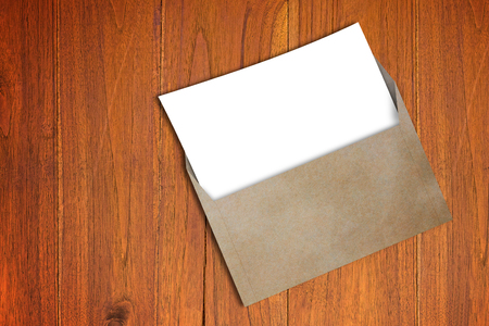 Open business envelope, blank white paper on wood backgroundの写真素材