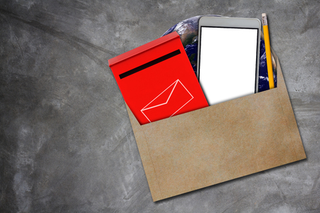Communication concept, red mail box, mobile phone and yellow pencil on concrete background,