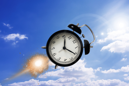 Time management concept, fly alarm clock on sky backgroundの写真素材
