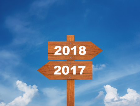 New year concept background, wooden sign 2017 and 2018 on blue sky, future aheadの写真素材