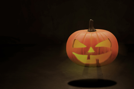 Halloween pumpkin head on dark tone background, copy spaceの写真素材
