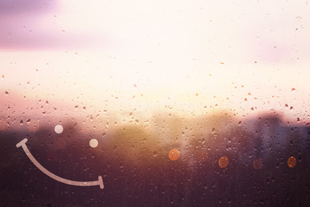 Happiness concept, drawing smile on sun sky backgroundの写真素材