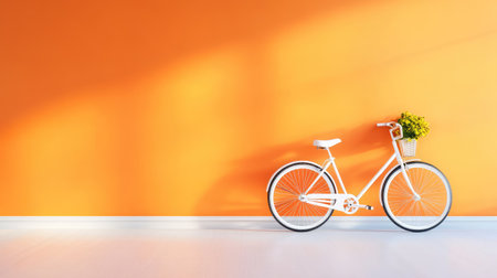 Retro bicycle positioned off-center against orange wall, strong copy space, ideal for summer promo or posterの素材