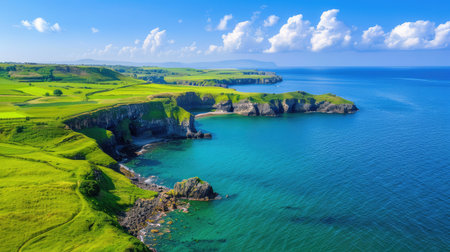 This stunning aerial view captures a vibrant coastal landscape featuring majestic cliffs, serene blue waters, and lush green fields, perfect for nature lovers.の素材