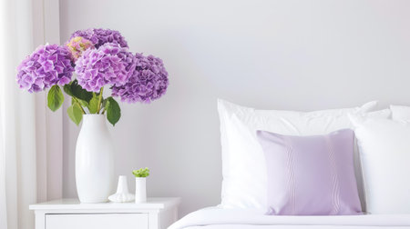 A stunning display of purple hydrangeas in a stylish vase brings life to a cozy bedroom. The soft colors and elegant bedding create a tranquil atmosphere perfect for relaxation.の素材