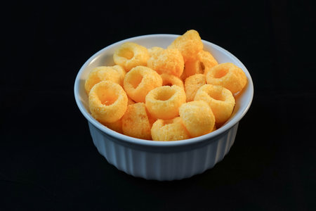 Snacks in the white bowl with black baclground