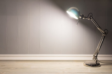 Copy space of Silver Table lamp turn light wood table with grey background