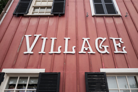 White village word sign on old red color wood house with windowsの写真素材