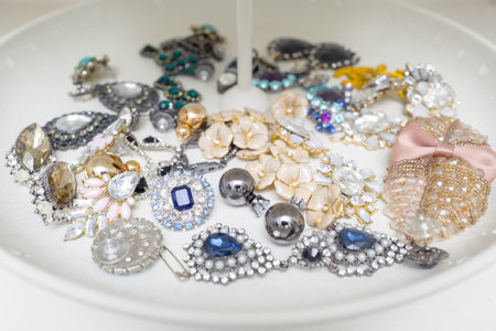 Closeup many type of earrings on white trayの写真素材