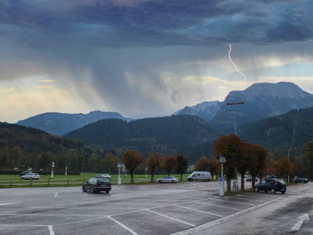 Car park at the mountain with storm and lightning in the backgroundの写真素材