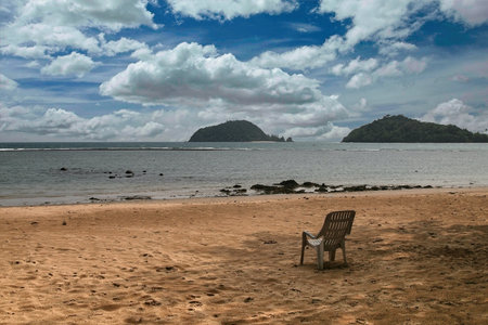 Seat at the beach with cloudy sky and islandの写真素材