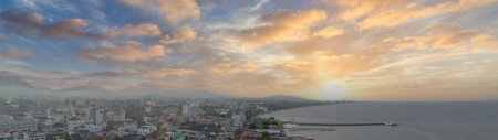 Panorama view of city by the sea with beautiful sky in sunset time