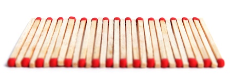 Matches on a row on white background.の写真素材