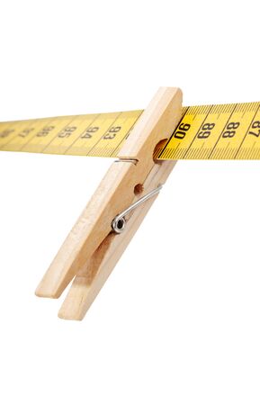 Clothespin and measuring tape isolated on a white  surface.の写真素材