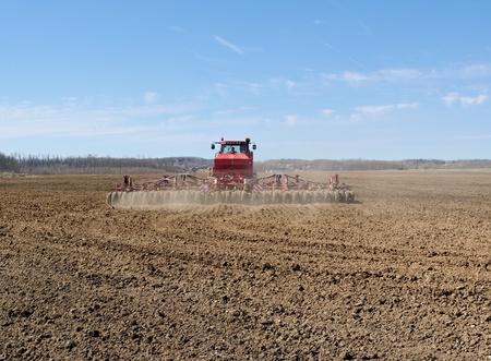 Tractor working on a big field.の写真素材