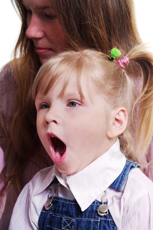 Yawning small girl and young woman.の写真素材