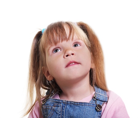 Small smiling girl is looking up.の写真素材