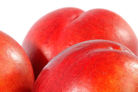Detail of juicy peachs on white surface.の写真素材