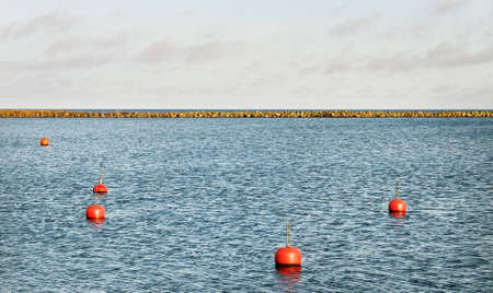 Red buoy above sea water の写真素材