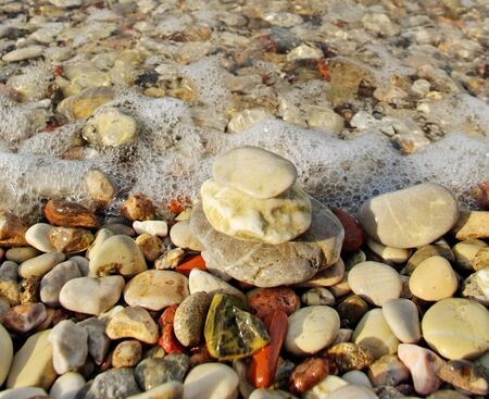 Sea pebbles on the beach in a summer day の写真素材
