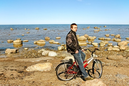 Man with bike at sea 