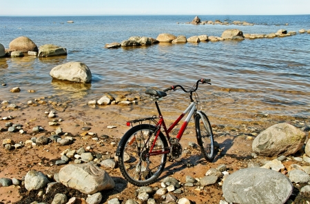 Bike on stone beach at the sea の写真素材