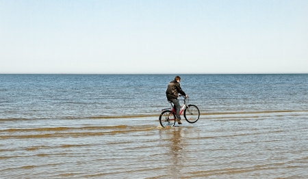Man with bike at the Baltic sea.の写真素材