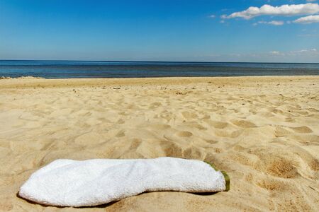 Grey towel on sand at the sea の写真素材