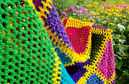 Homemade blanket on the flower bad background 