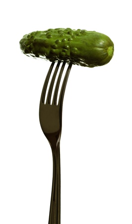 Fork with marinated cucumber on white surface の写真素材