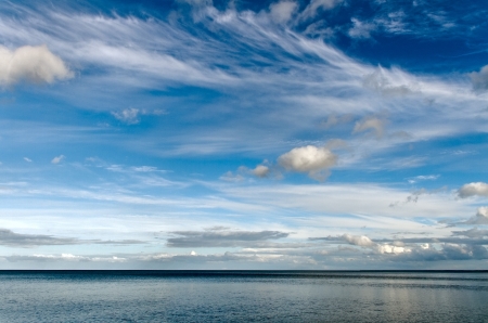 Cloudy day above blue sea の写真素材