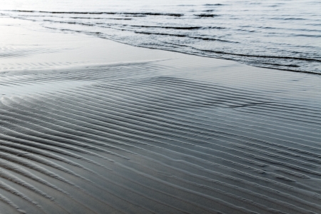 Wet sand surface at the sea の写真素材