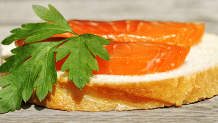 Red slice of salmon on the white bread.の写真素材